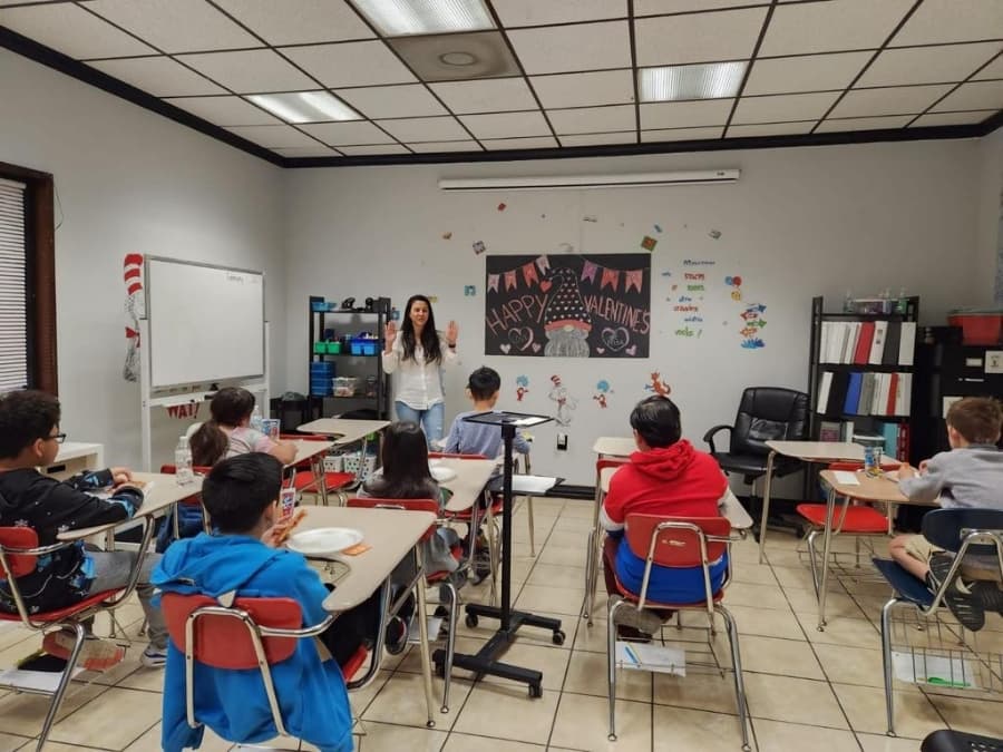A teacher leading a classroom of students during a lesson